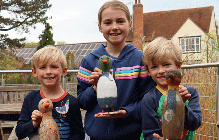 Image: children with painted ducks