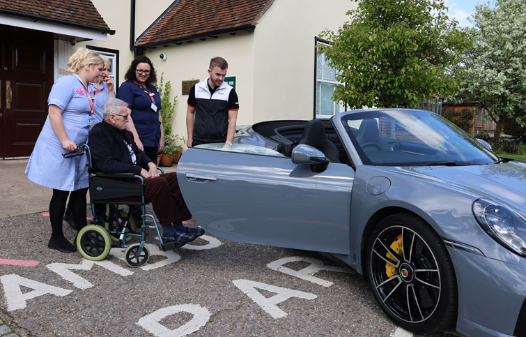 Image: Tony admires a Porsche outside St Helena Hospice
