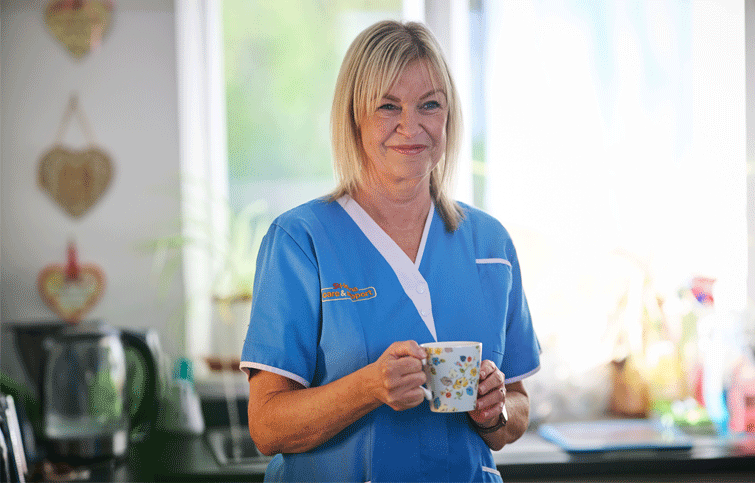 Helena Care & Support Staff carrying cup of tea for clients