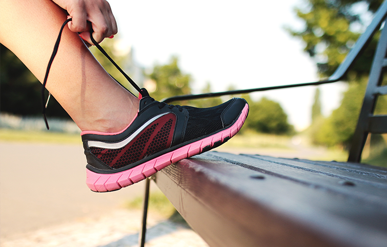 Tying a shoelace against a bench