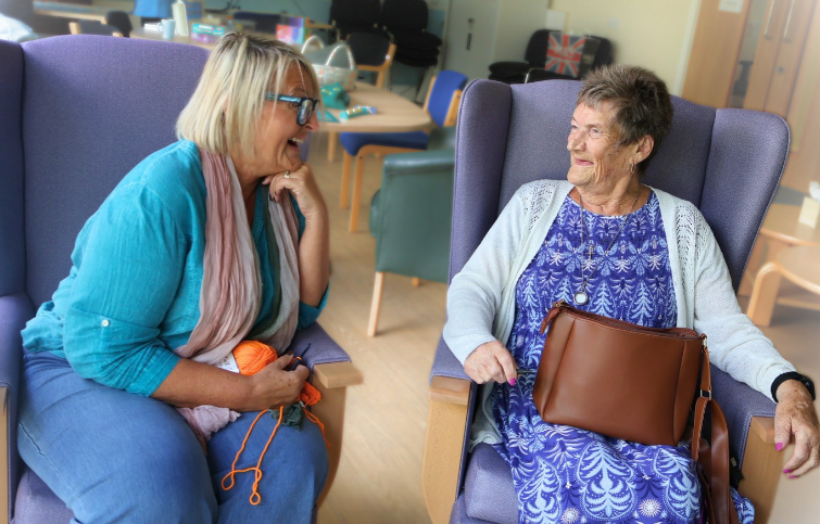 A lady and her carer enjoying being out the house and mingling with other people