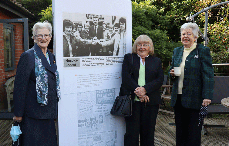 Pat, Rita and Dorothy next to a photo of the Cherrydale Weavers pictured in the newspaper in the early 1980s: Sue Dowrick, Jane Entwistle, Beryl Hutley, Pat Adams, hospice chairman Chris Holmes, Maureen Poulter, Rita Pincombe, Elizabeth Cook, Dorothy Hewitt