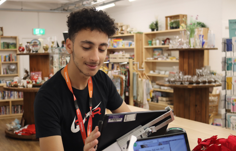 A male volunteer working on the cash register