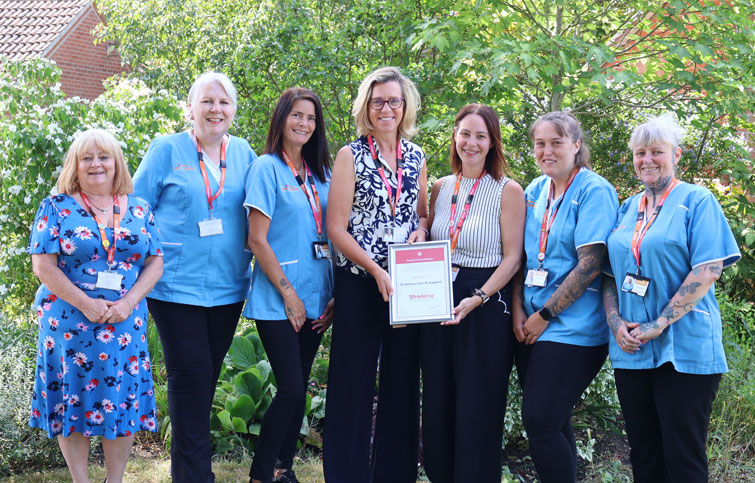 Image: St Helena Care & Support team receiving award from Dr Karen Chumbley co-chief executive of St Helena Hospice