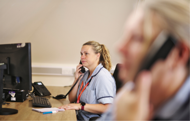 A SinglePoint nurse on the phone sat at a computer