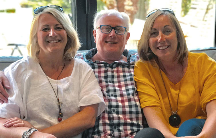Image: St Helena Hospice patient Peter with his two daughters either side
