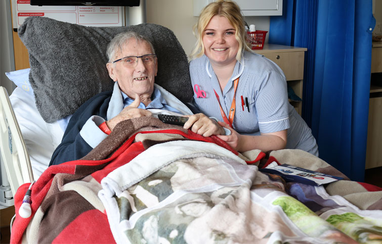 Image: Tony gives thumbs up at St Helena Hospice with clinical support worker Poppie