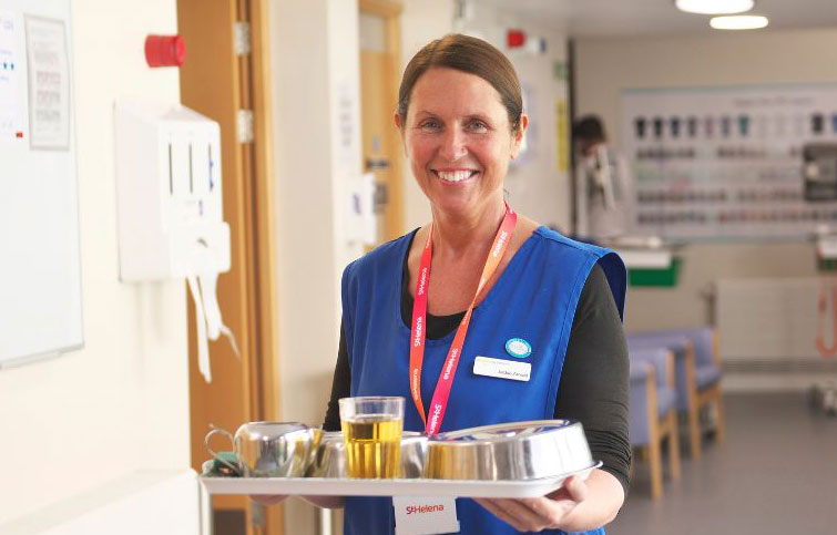 woman carrying tray of food