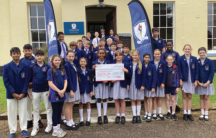 Year 6 students at Littlegarth school with fundraising cheque.