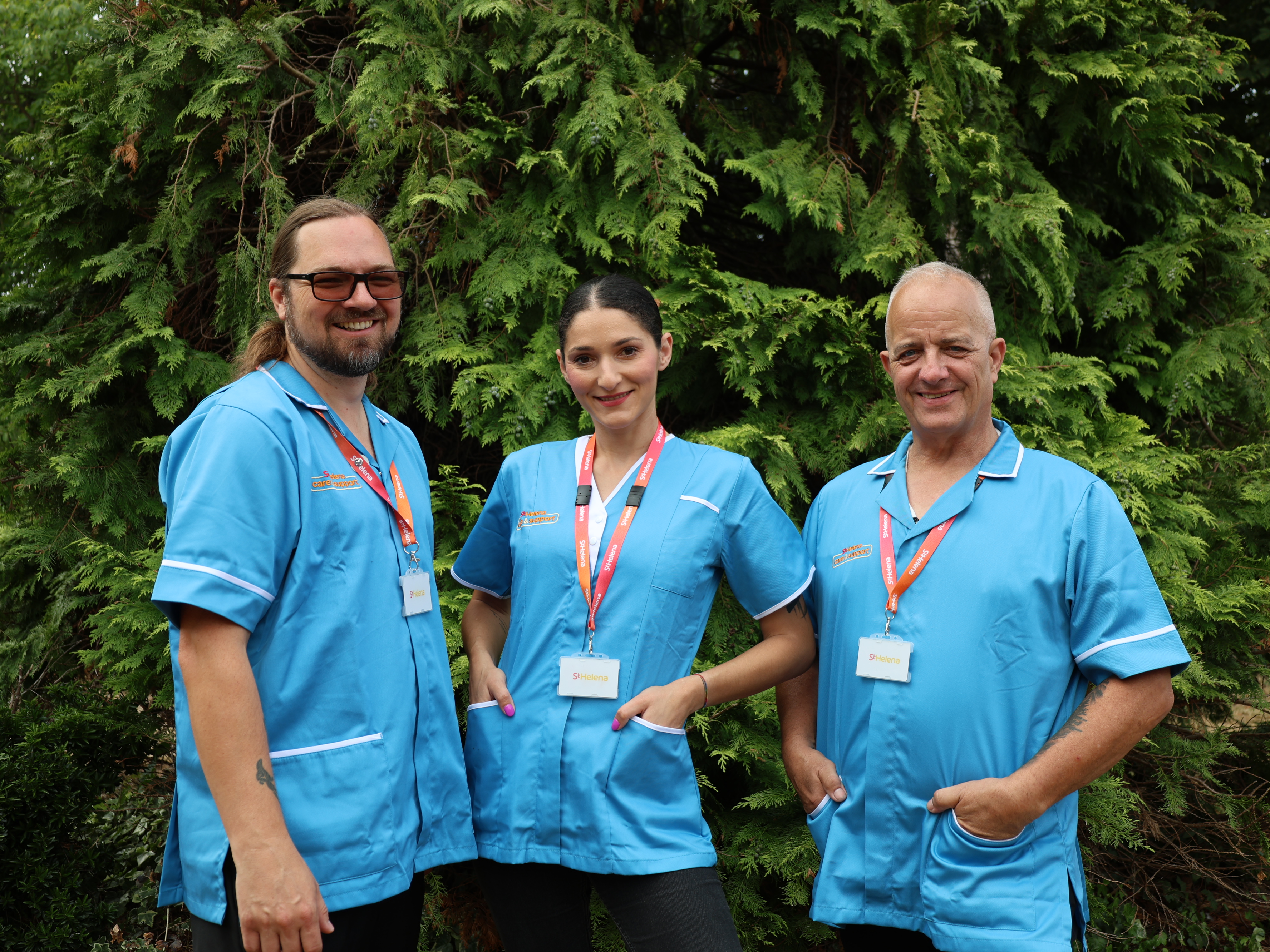 Three smiling Home Care nurses in the garden