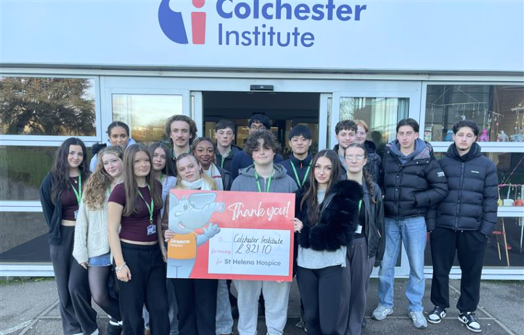 Students at Colchester Institute showing how much money they raised for St Helena Hospice