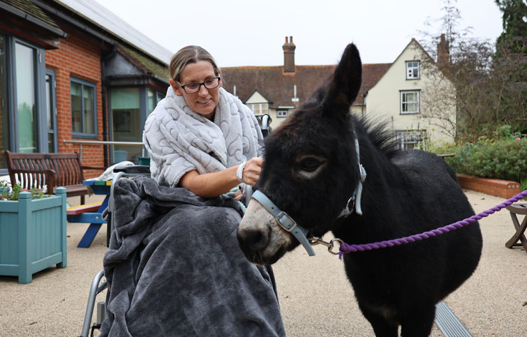 Image: patient Julie meets a donkey at St Helena Hospice