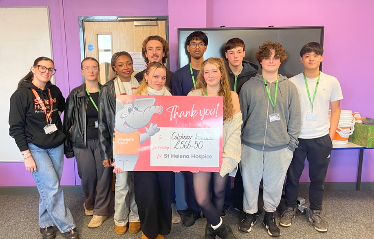 Students from Colchester Institute showing how much they raised for St Helena Hospice