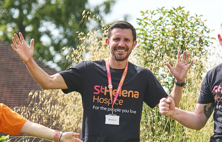 A fundraiser waving at the camera