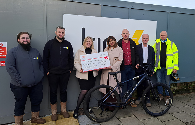 Kind & Co presenting how much they have raised for St Helena Hospice