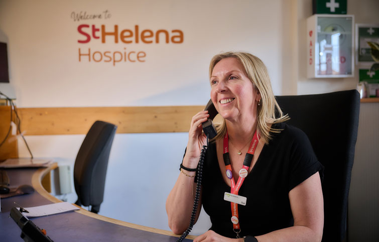 Sue volunteering on reception at St Helena Hospice