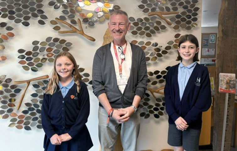 Two ten year old girls visited St Helena Hospice to write an article for the newspaper, here they are pictured with fundraiser James